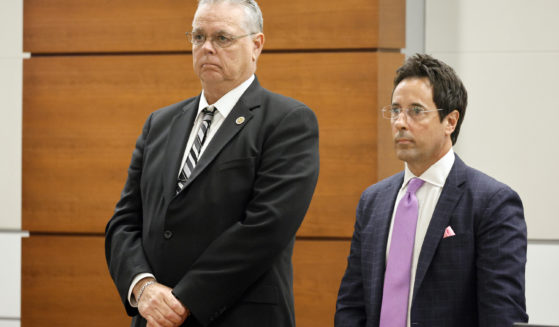 Former Marjory Stoneman Douglas High School School Resource Officer Scot Peterson, left, and defense attorney Mark Eiglarsh, right, stand as the jury enters the courtroom to be dismissed on Wednesday from Broward County Courthouse in Fort Lauderdale, Florida.