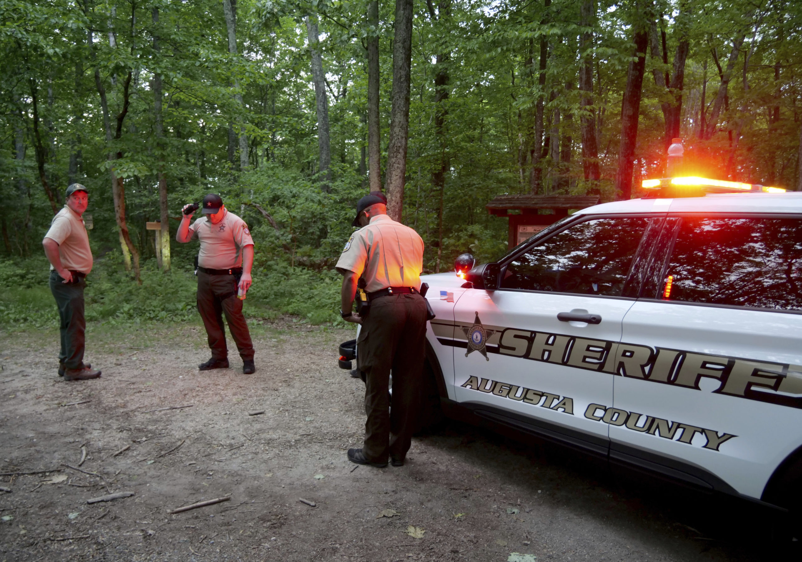 Authorities secure the entrance to Mine Bank Trail, an access point to the rescue operation along the Blue Ridge Parkway where a Cessna Citation crashed over mountainous terrain near Montebello, Virginia, Sunday.