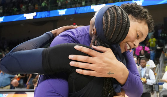 Brittney Griner, right, hugs former college teammate Odyssey Sims, left, after a WNBA basketball basketball game in Arlington, Texas, on Friday.