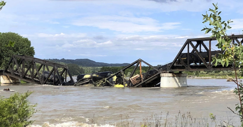 Train cars are immersed in the Yellowstone River after a bridge collapse near Columbus, Montana, on Saturday.