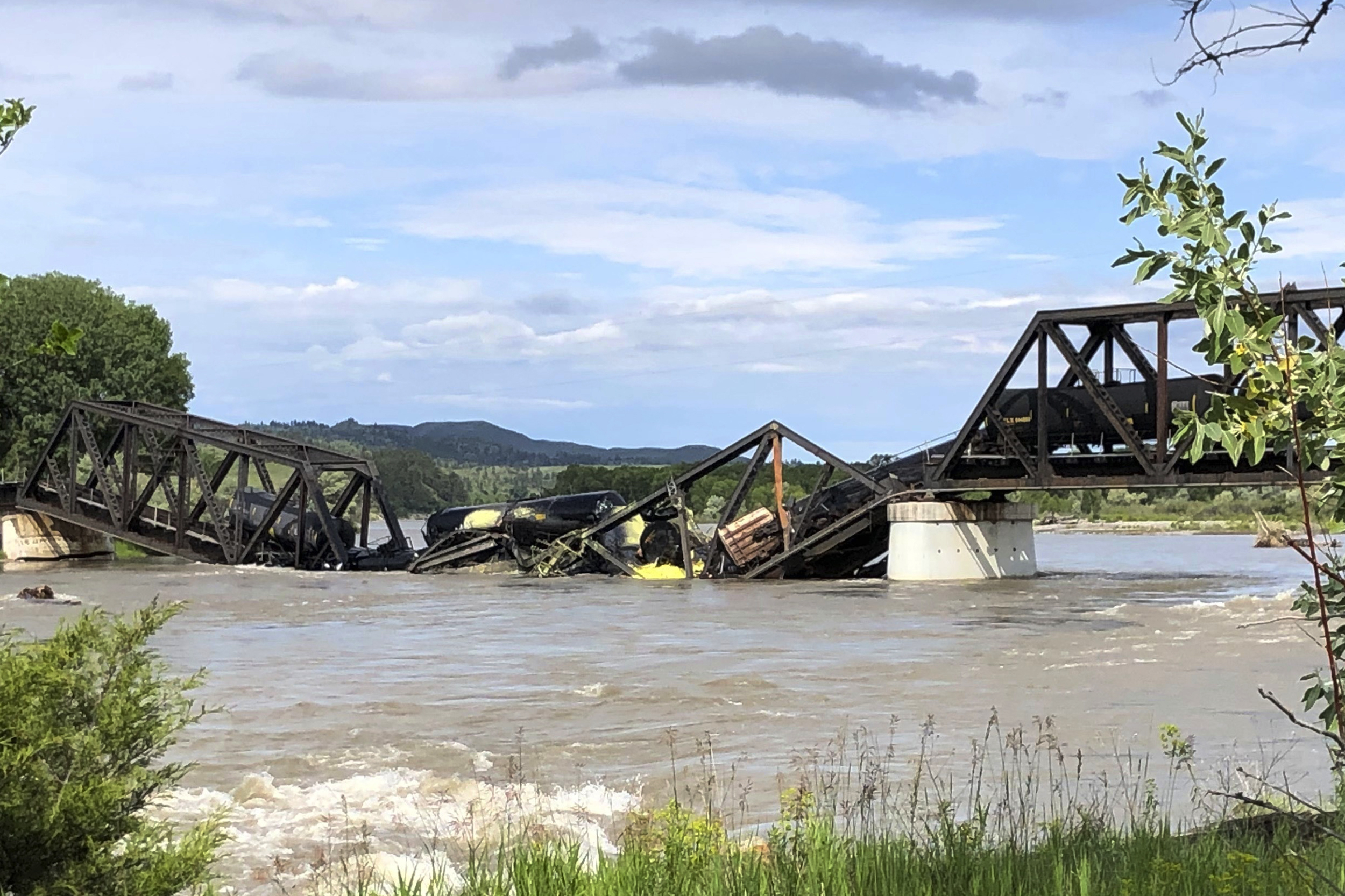 Train cars are immersed in the Yellowstone River after a bridge collapse near Columbus, Montana, on Saturday.