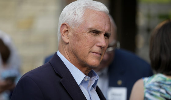 Former Vice President Mike Pence talks with local residents during a meet and greet May 23 in Des Moines, Iowa. Pence will officially launch his widely expected campaign for the Republican nomination for president in Iowa on June 7.