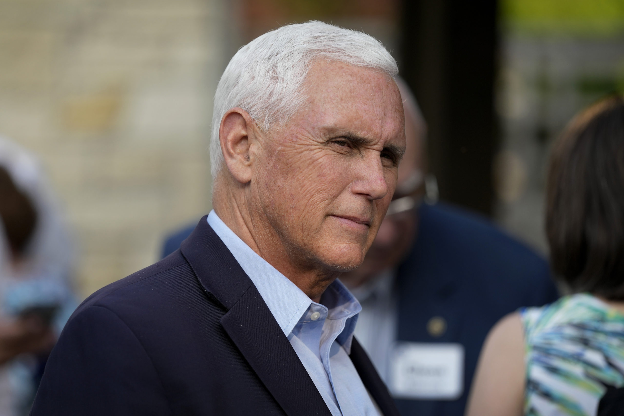 Former Vice President Mike Pence talks with local residents during a meet and greet May 23 in Des Moines, Iowa. Pence will officially launch his widely expected campaign for the Republican nomination for president in Iowa on June 7.