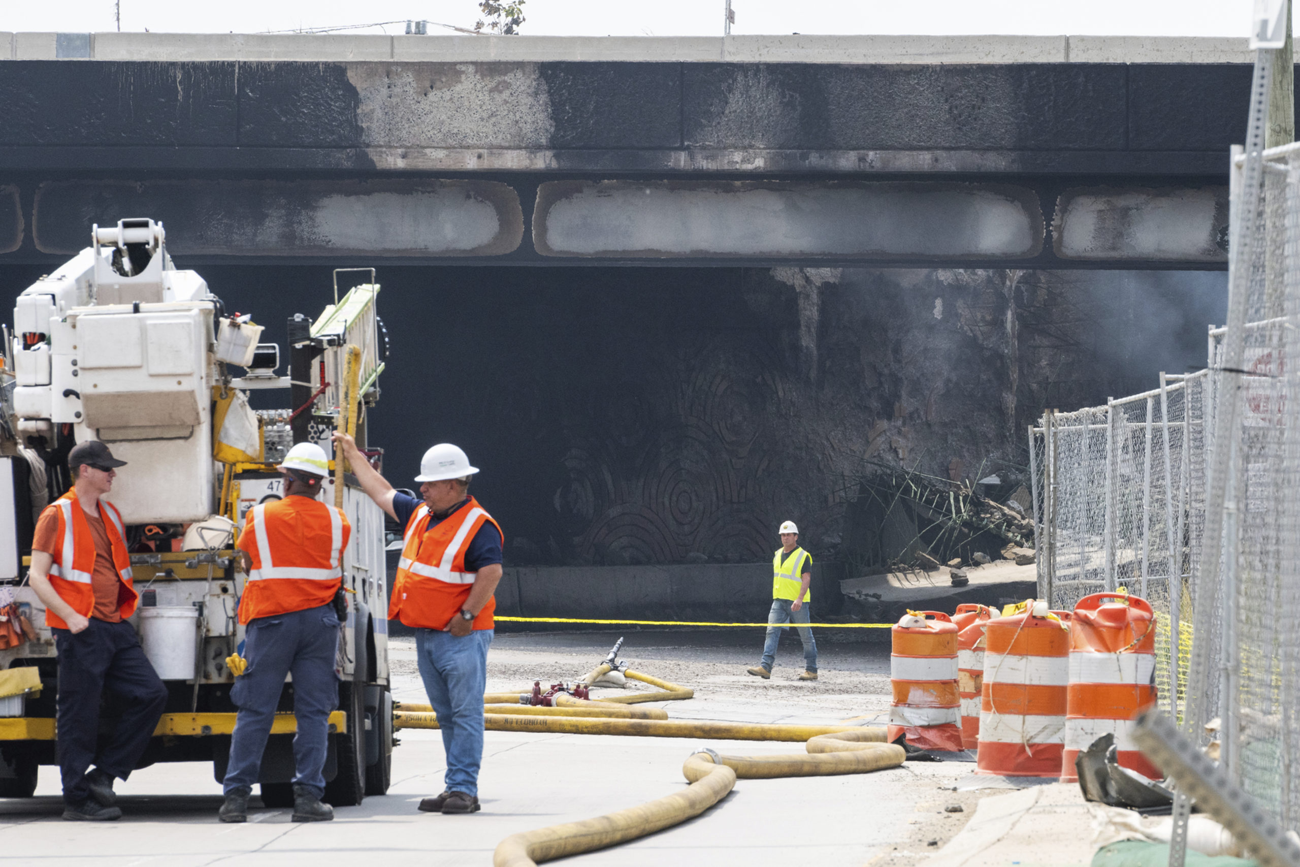 Officials work on the scene following a collapse on I-95 after a truck fire in Philadelphia on Sunday.