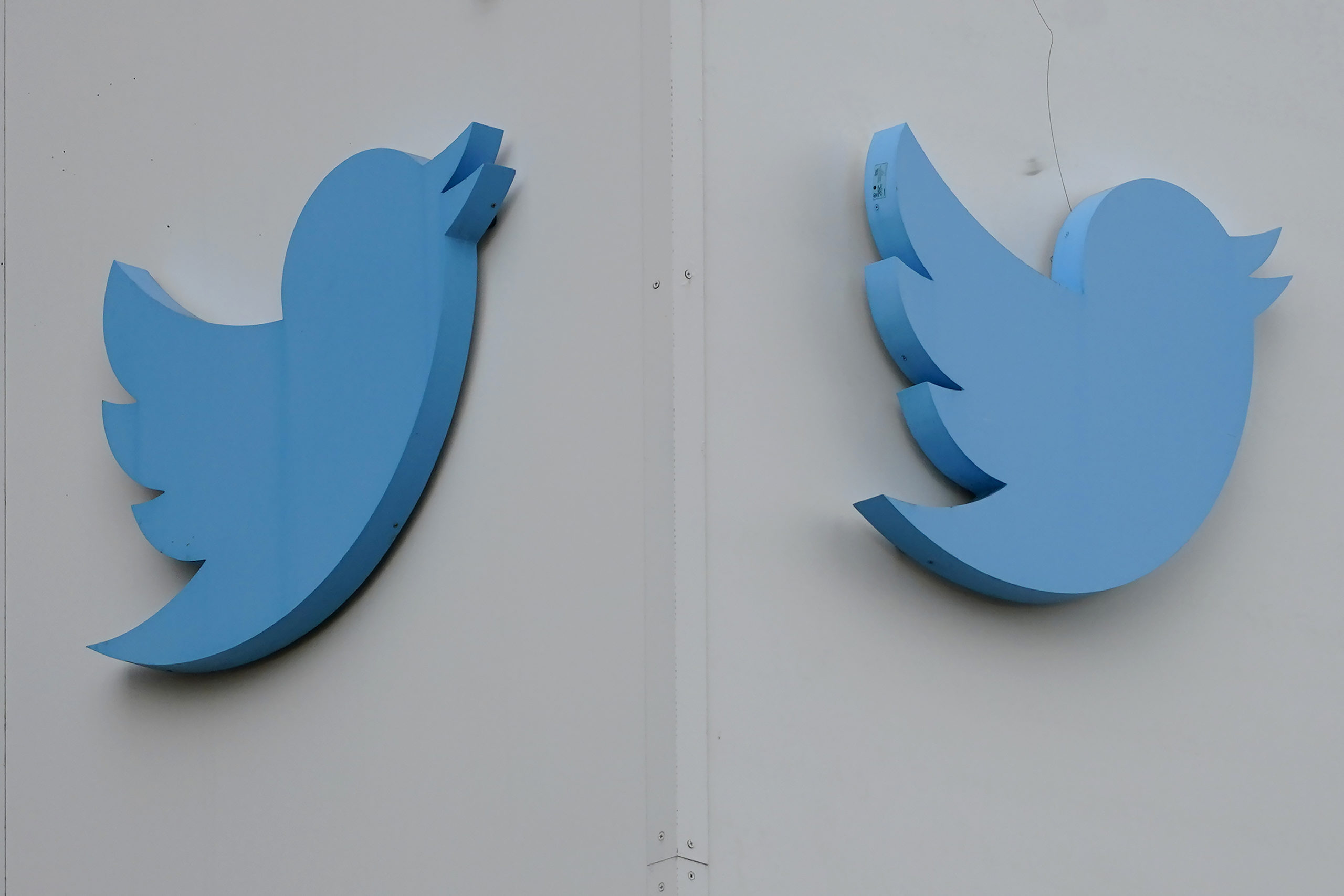 Twitter logos hang outside the company's offices in San Francisco in December. Ella Irwin, Twitter's head of trust and safety, has left the company.