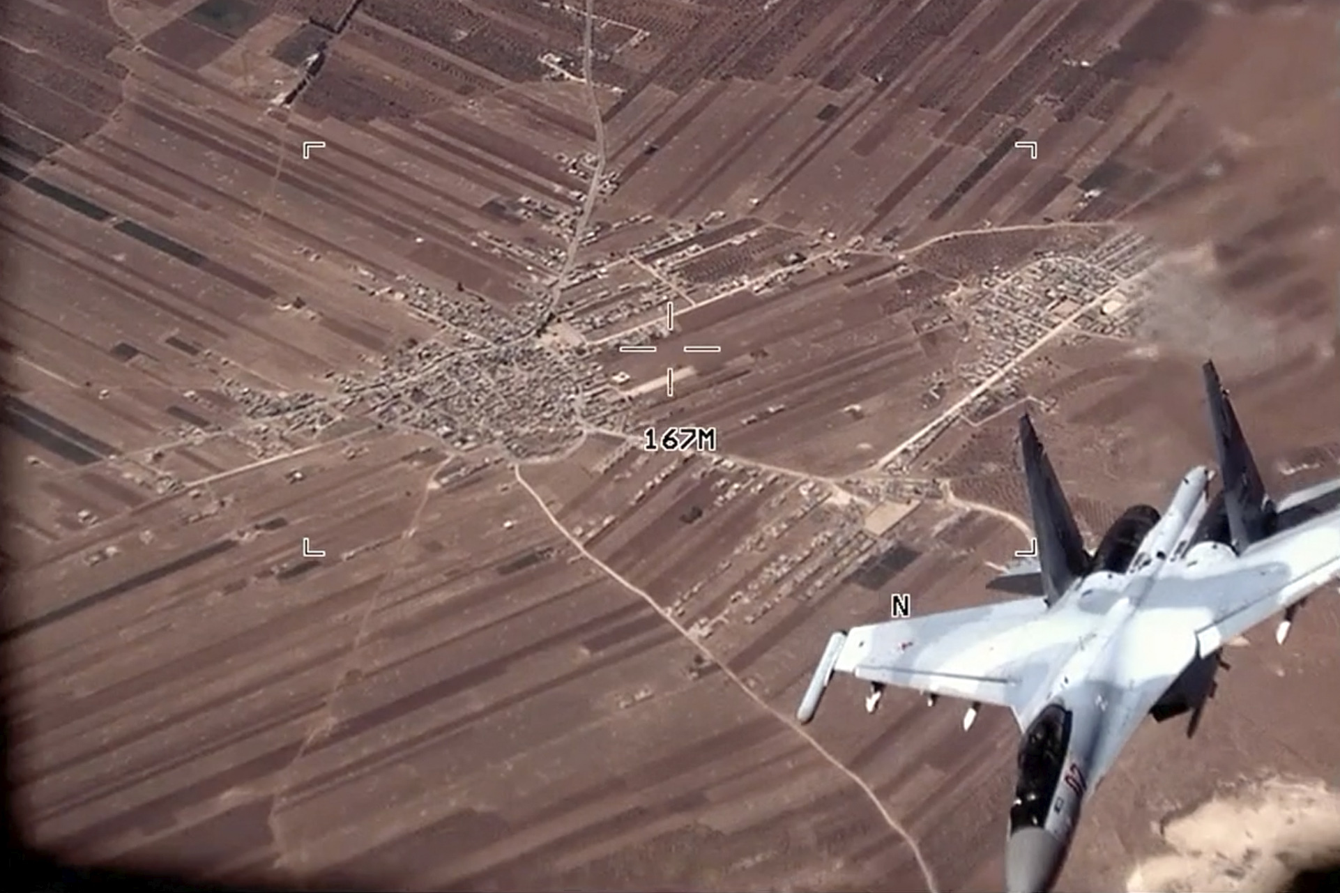 In this image from a video released by the U.S. Air Force, a Russian Su-35 flies near a U.S. Air Force MQ-9 Reaper drone on July 5, over Syria.