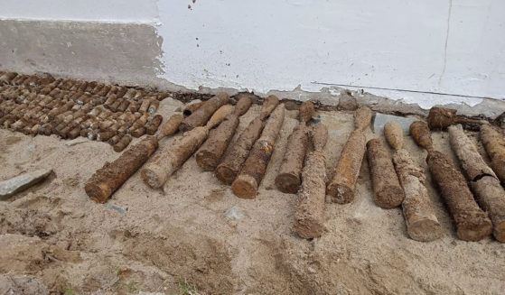 A photo released by the Cambodia Mine Action Center shows dirt-caked, unexploded ordnance at Queen Kosamak High School in Kratie Province, northeast of Phnom Penh, Cambodia, on Sunday.