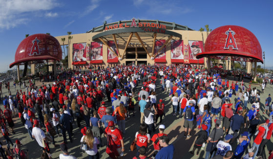 Fans line up outside Angel Stadium in Anaheim, California, for an opening day baseball game between the Los Angeles Angels and the Chicago Cubs on April 4, 2016.