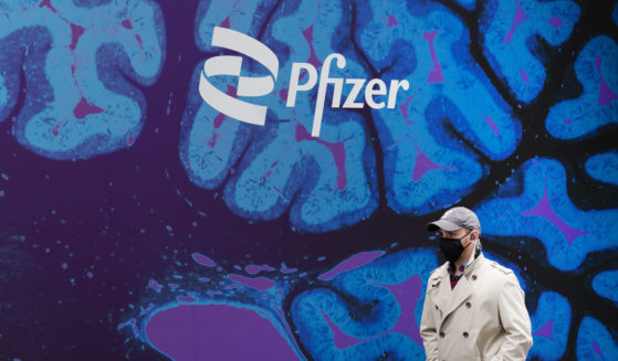 A man walks by Pfizer headquarters in New York City on Feb. 5, 2021.