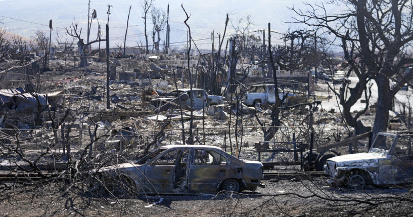 Homes and cars destroyed by a devastating fire are seen Sunday in Lahaina, Hawaii.