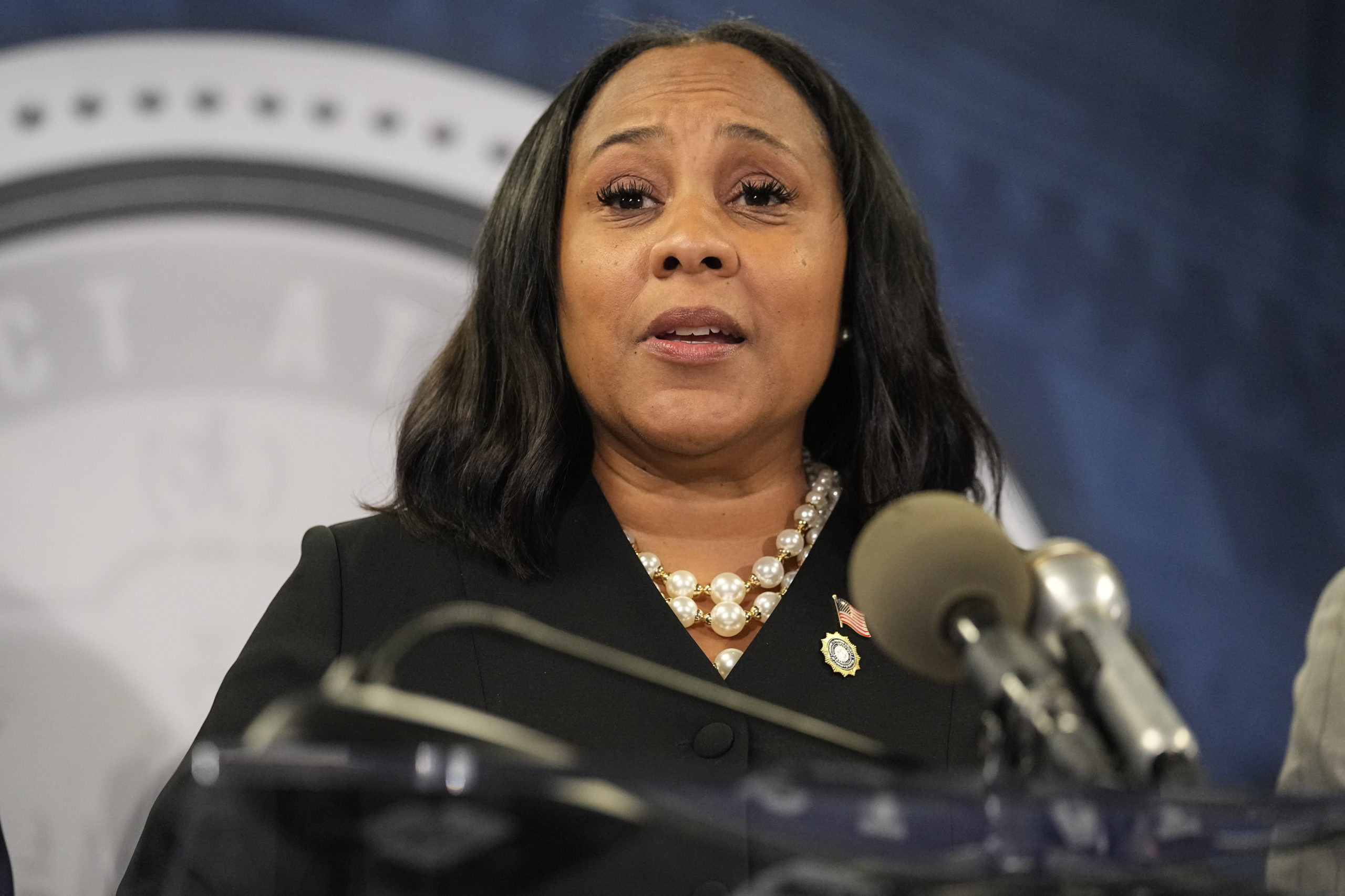 Fulton County District Attorney Fani Willis speaks in the Fulton County Government Center during a news conference in Atlanta on Aug. 14.