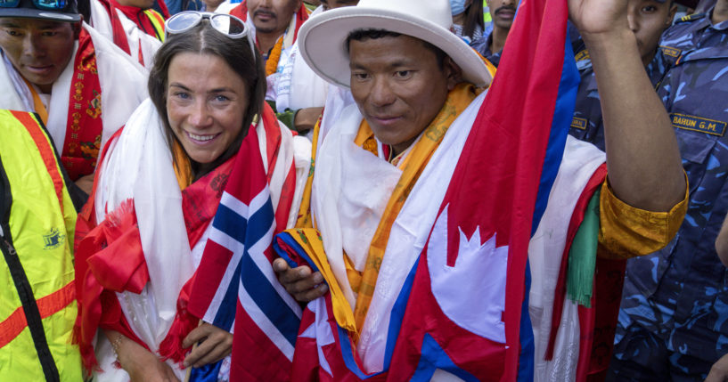 Norwegian climber Kristin Harila, left, and her Nepali sherpa guide Tenjin Sherpa, right, who climbed the world’s 14 tallest mountains in record time, arrive in Kathmandu, Nepal, on Aug. 5.