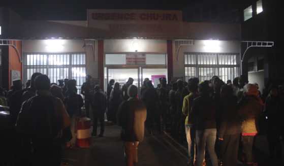 People gather outside a hospital in Antananarivo. Madagascar, on Friday to find out the status of loved ones after a stampede at a local stadium. At least 12 people died in the stampede in the opening ceremony for the Indian Ocean Island Games.