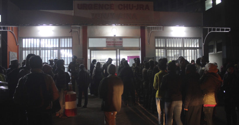 People gather outside a hospital in Antananarivo. Madagascar, on Friday to find out the status of loved ones after a stampede at a local stadium. At least 12 people died in the stampede in the opening ceremony for the Indian Ocean Island Games.