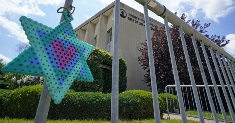 A Star of David hangs from a fence outside the dormant landmark Tree of Life synagogue in Pittsburgh's Squirrel Hill neighborhood on July 13, the day a federal jury announced they had found Robert Bowers, who in 2018 killed 11 people at the synagogue, eligible for the death penalty.