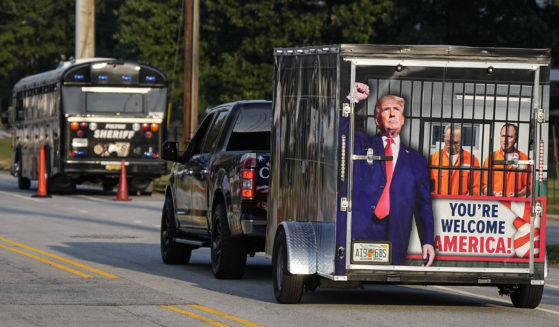 A vehicle and trailer pass the Fulton County Jail in Atlanta on Thursday.