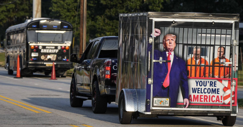 A vehicle and trailer pass the Fulton County Jail in Atlanta on Thursday.