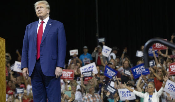 Former President Donald Trump stands as the crowd cheers at the South Dakota Republican Party Monumental Leaders rally in Rapid City, South Dakota, on Friday.