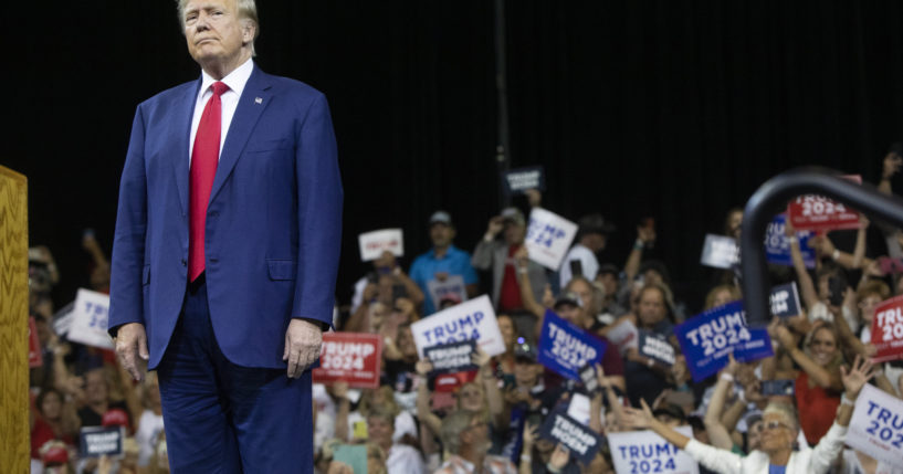 Former President Donald Trump stands as the crowd cheers at the South Dakota Republican Party Monumental Leaders rally in Rapid City, South Dakota, on Friday.