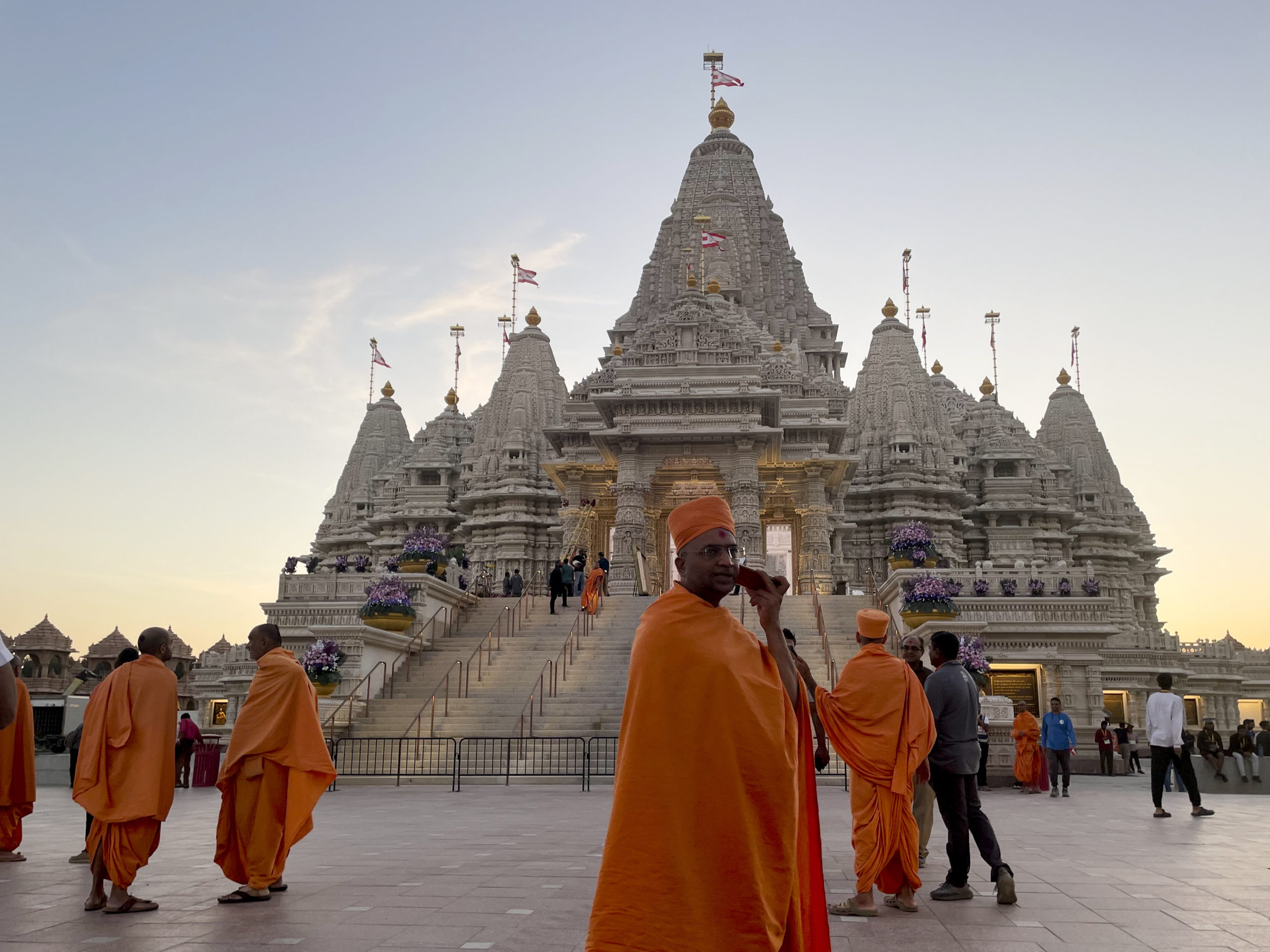 Monks in saffron robes walk in front of the BAPS Swaminarayan Akshardham temple on Wednesday in Robbinsville, New Jersey.