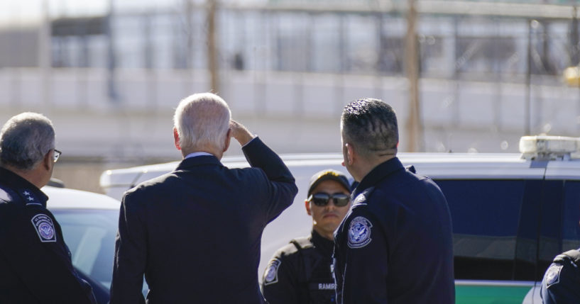 President Joe Biden, second from left, looks towards a large “Welcome to Mexico” sign that is hung over the Bridge of the Americas as he tours the El Paso, Texas, port of entry on Jan. 8.