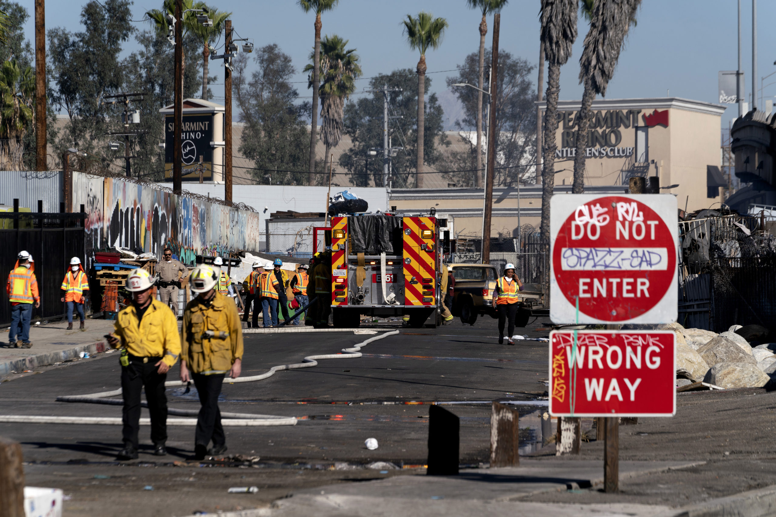 Los Angeles firefighters work to clean up the damage from a fire that severely damaged part of Interstate 10 in Los Angeles on Saturday. There has been no date given for when the section of road will reopen.