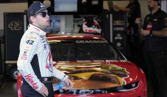 Noah Gragson stands by his car in his garage during a practice session for the NASCAR Daytona 500 auto race at Daytona International Speedway in Daytona Beach, Florida, on Feb. 17.