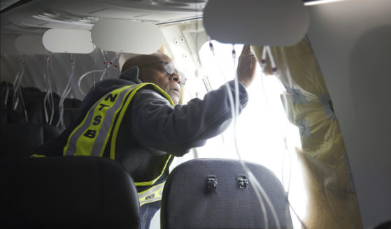 NTSB Investigator-in-Charge John Lovell examines the fuselage plug area of American Airlines flight 1282 on Saturday in Portland, Oregon.