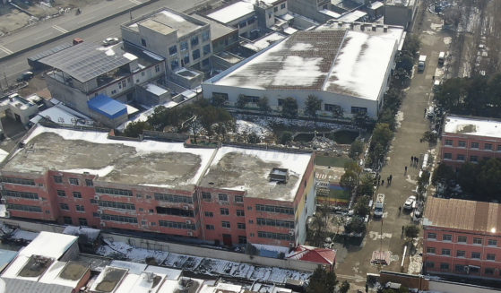 In this photo released by Xinhua News Agency, an aerial drone Saturday shows a dormitory with charred windows after a fire broke out at the Yingcai School in central China's Henan province.