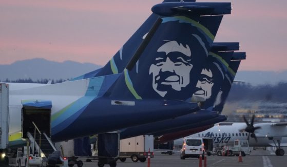 An Alaska Airlines flight made an emergency landing Friday in Oregon after a window and chunk of its fuselage blew out in mid-air, media reports said.