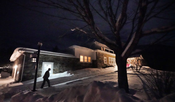 A man arrives Monday evening at the Tillotson House where six voters in the hamlet of Dixville Notch, New Hampshire, voted Tuesday in the New Hampshire Republican primary.