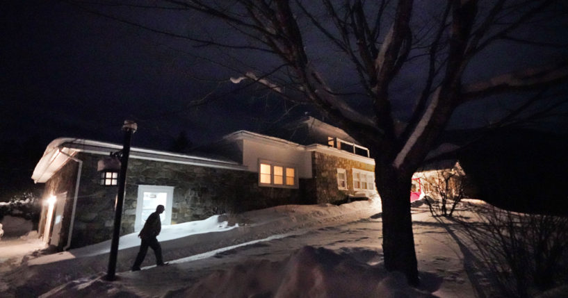 A man arrives Monday evening at the Tillotson House where six voters in the hamlet of Dixville Notch, New Hampshire, voted Tuesday in the New Hampshire Republican primary.