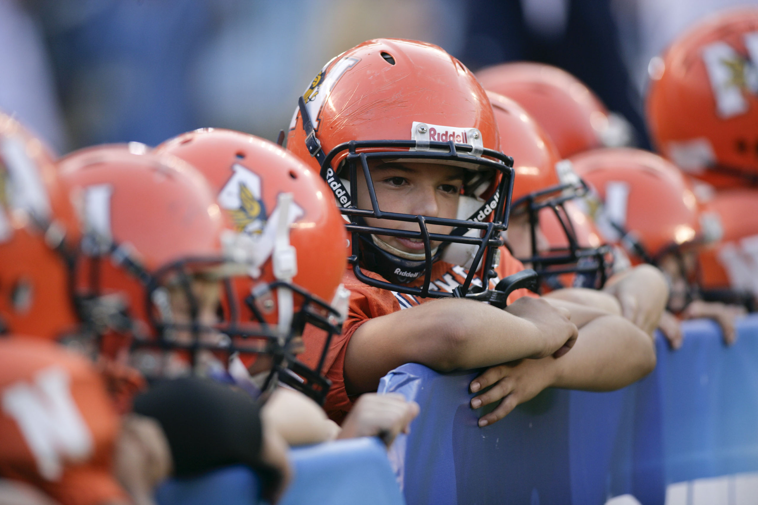 Pop Warner football players look on before an NFL pre-season game between the San Francisco 49ers and the San Diego Chargers in San Diego, California, on Sept. 4, 2009. The California Legislature is considering a bill that would ban children under the age of 12 from competing in tackle football in an effort to reduce brain injuries.