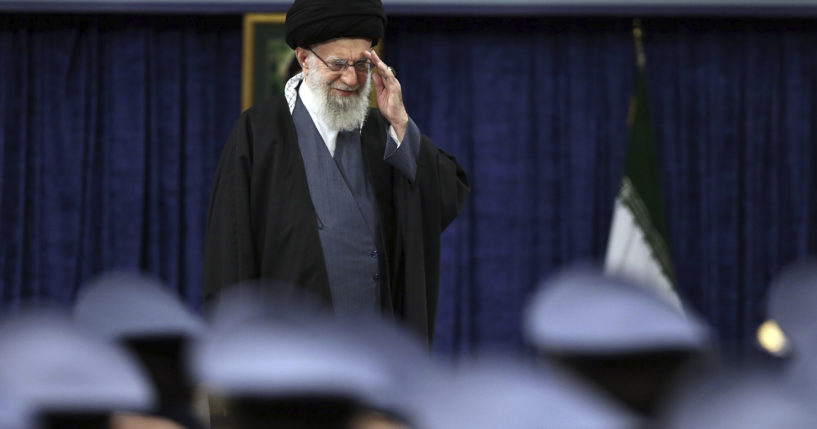 Iranian Supreme Leader Ayatollah Ali Khamenei salutes during a meeting with military staff in Tehran on Monday.