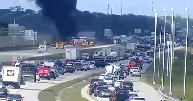 Smoke fills the air after an airplane crashed on Interstate 75 on Friday near Naples, Florida. Two people died in the crash.