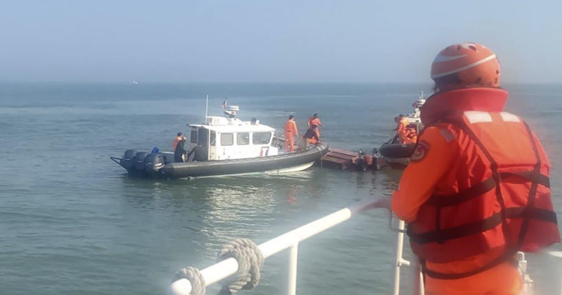 aiwanese coast guards inspect a vessel that capsized during a chase off the coast of Kinmen archipelago in Taiwan on Wednesday.