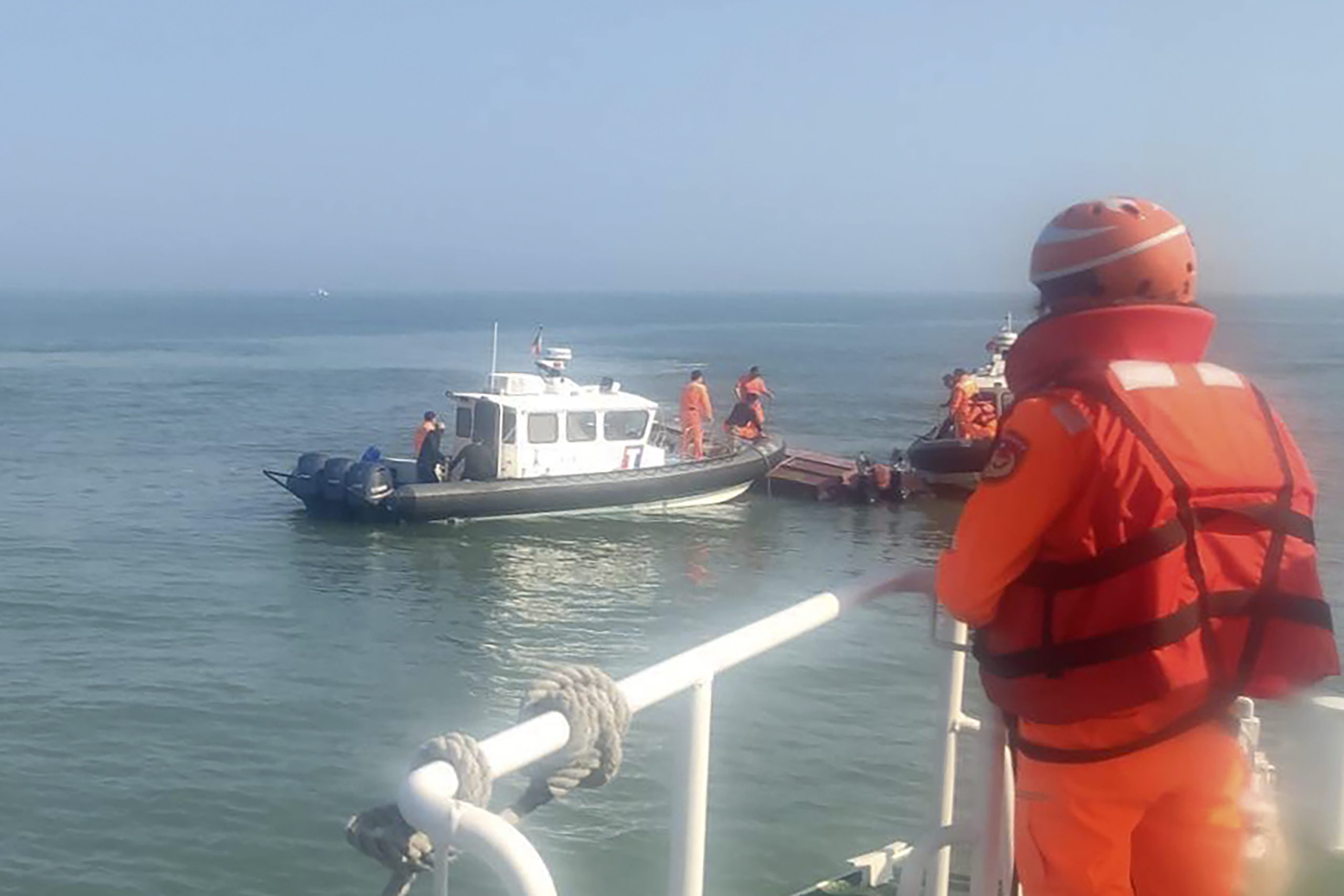 aiwanese coast guards inspect a vessel that capsized during a chase off the coast of Kinmen archipelago in Taiwan on Wednesday.