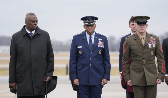 Defense Secretary Lloyd Austin, Chairman of the Joint Chiefs of Staff Gen. Charles Q. Brown, and Marine Corps. Sgt. Maj. Troy E. Black watch as an Army carry team moves the flag-draped transfer case containing the remains of U.S. Army Sgt. Kennedy Ladon Sanders, 24, of Waycross, Georgia, during a casualty return at Dover Air Force Base in Delaware on Friday. Sanders was killed in a drone attack in Jordan on Sunday.