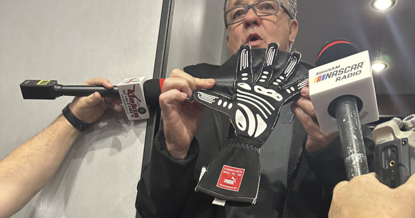 NASCAR Cup Series Managing Director Brad Moran shows reporters the illegal glove Joey Logano of Team Penske was reportedly caught wearing during qualifying in February at Atlanta Motor Speedway.