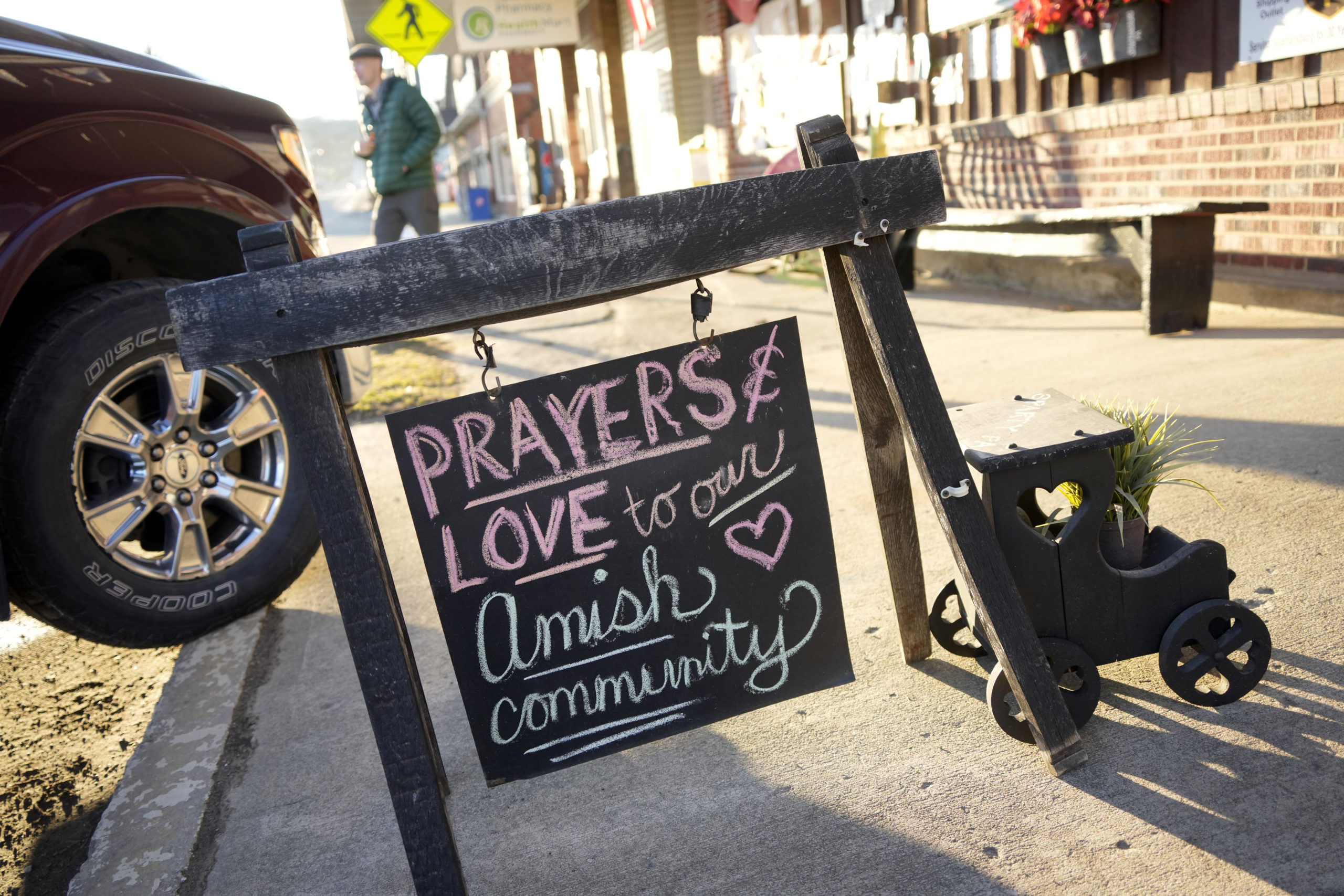 A sign of comforting words sits on the sidewalk outside an antique store in Spartansburg, Pennsylvania, on Thursday in the wake of the slaying of a pregnant Amish woman, 23, last week.