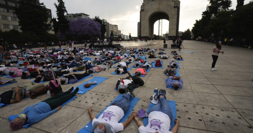 People lie at the base of the Monument to the Revolution to take a nap Friday in Mexico City in commemoration of World Sleep Day.