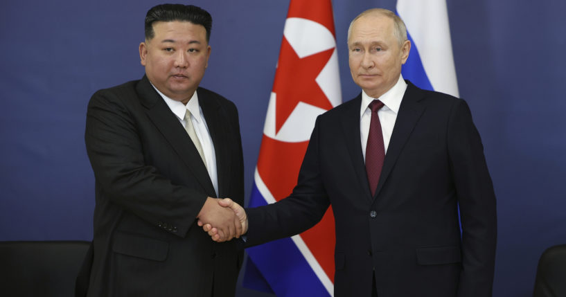 Russian President Vladimir Putin, right, and North Korea's leader Kim Jong Un are seen shaking hands in a file photo taken during a September meeting.