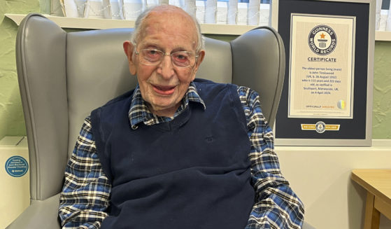 John Alfred Tinniswood, 111, poses in a photo issued Saturday by Guinness World Records.