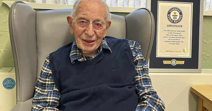 John Alfred Tinniswood, 111, poses in a photo issued Saturday by Guinness World Records.