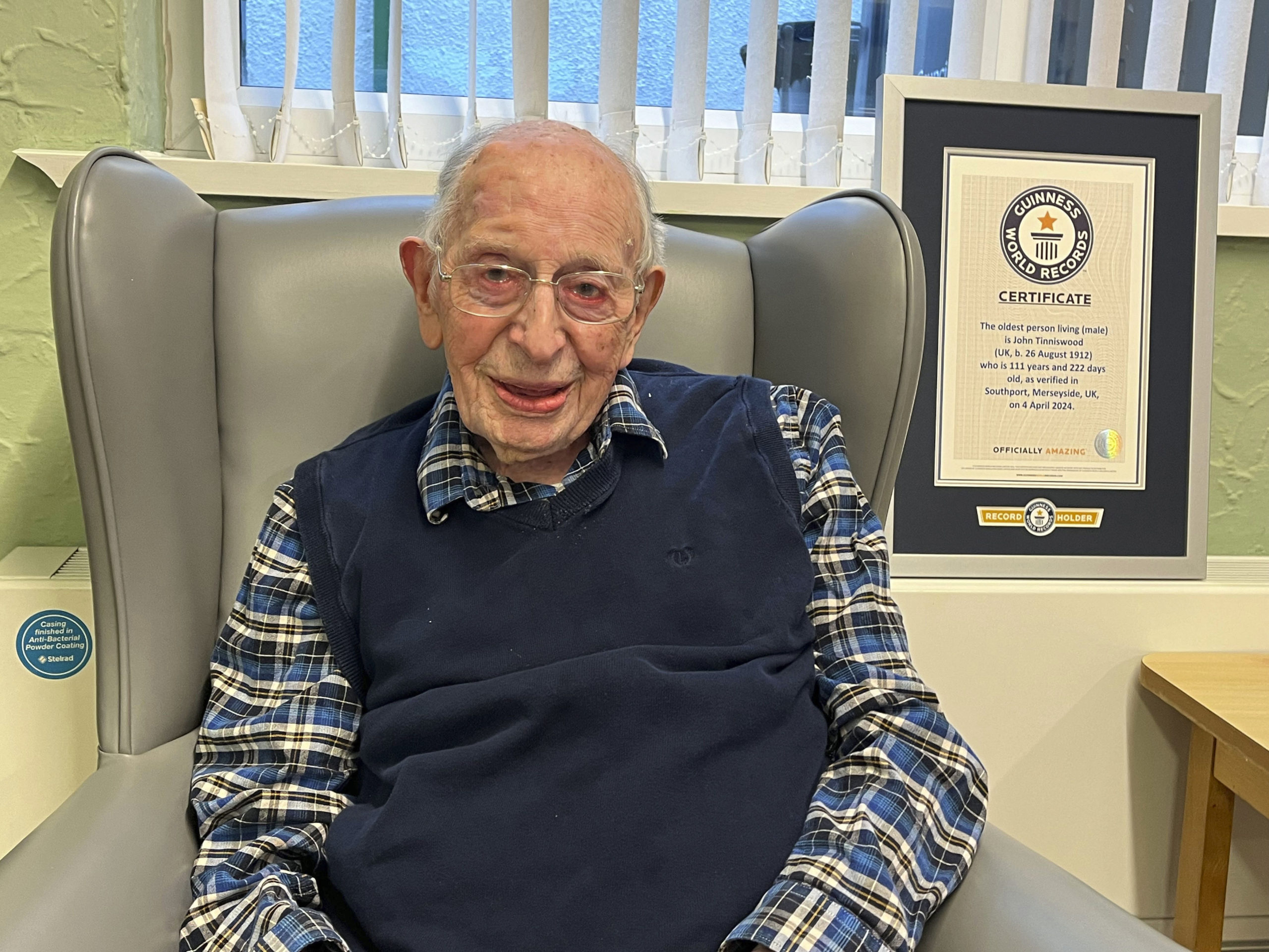 John Alfred Tinniswood, 111, poses in a photo issued Saturday by Guinness World Records.