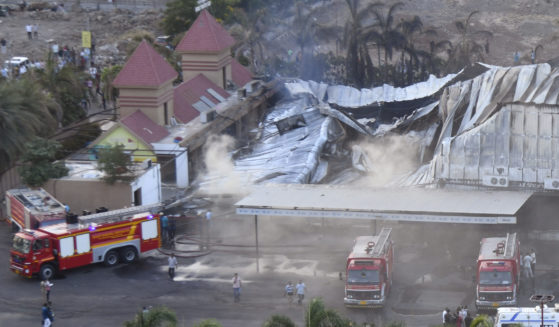 Firefighters douse a fire which broke out in an amusement park in Rajkot, in the Indian state of Gujarat, on May 25, 2024.