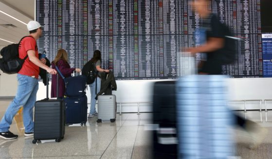 Passengers arrive at Terminal C at Orlando International Airport in Orlando, Florida on March 18.