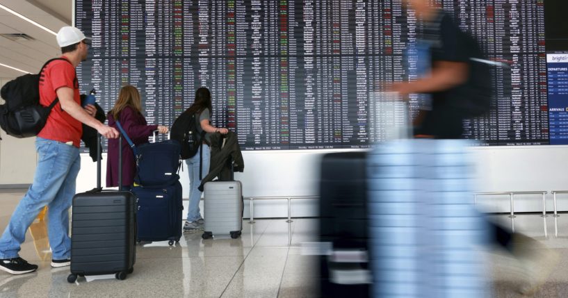 Passengers arrive at Terminal C at Orlando International Airport in Orlando, Florida on March 18.