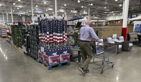 A shopper moves past a display of items in a Costco warehouse on May 18, 2024, in Sheridan, Colorado. As many Americans celebrate Memorial Day on Monday, May 27, 2024, there are several stores, government offices and businesses that will be open.