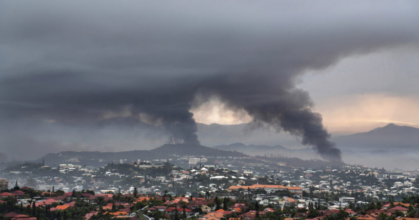 Smoke rises during armed clashes in Noumea, New Caledonia, on Wednesday. France has imposed a state of emergency in the French Pacific territory.